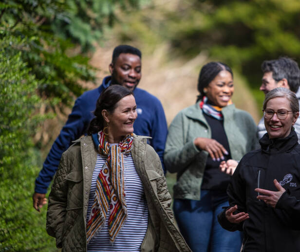 A group of people taking a walking tour along a pathway